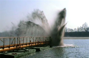 Dustpan motor dredger in operation